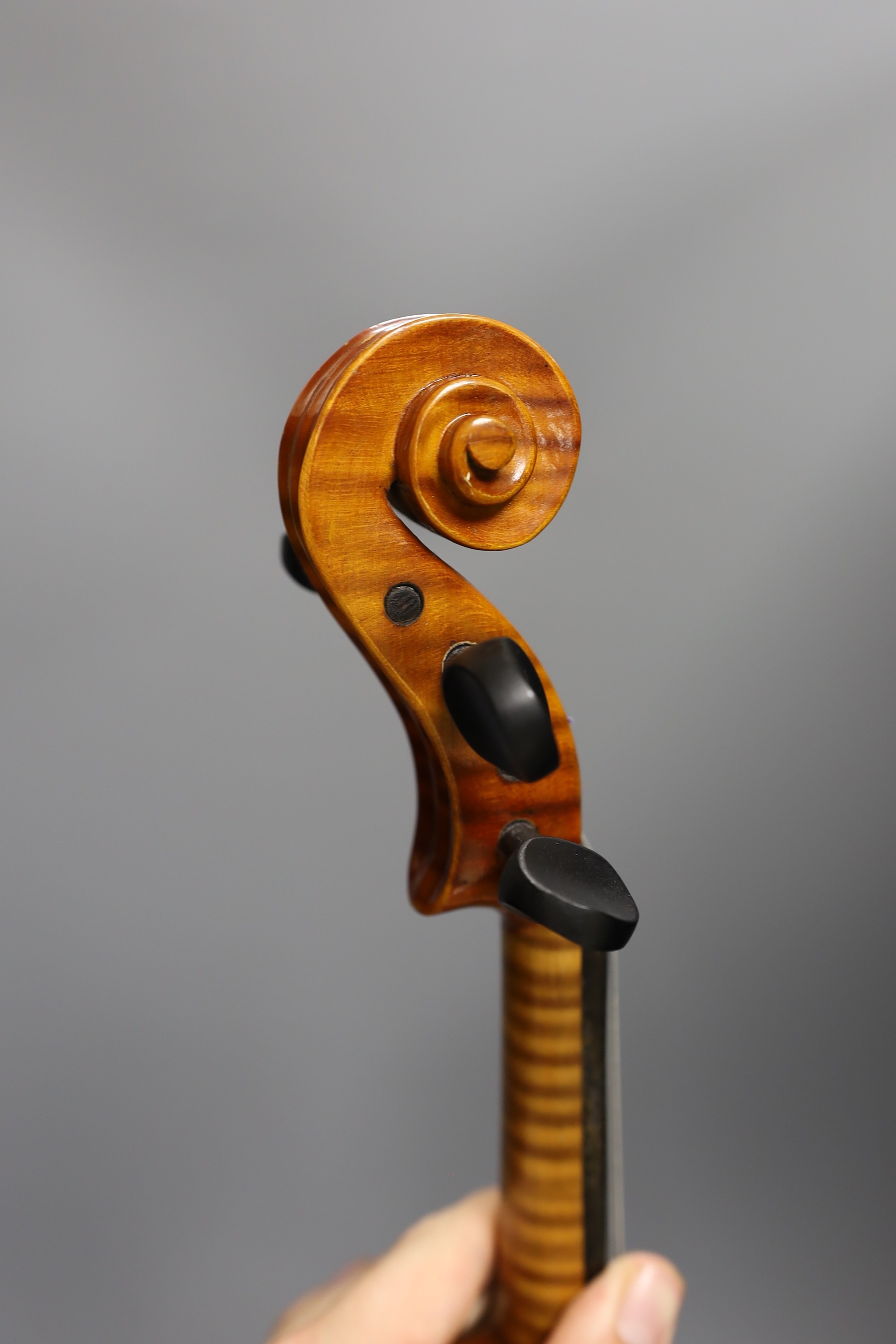 A cased child's violin and bow with ivorine tip, violin 55cms long
